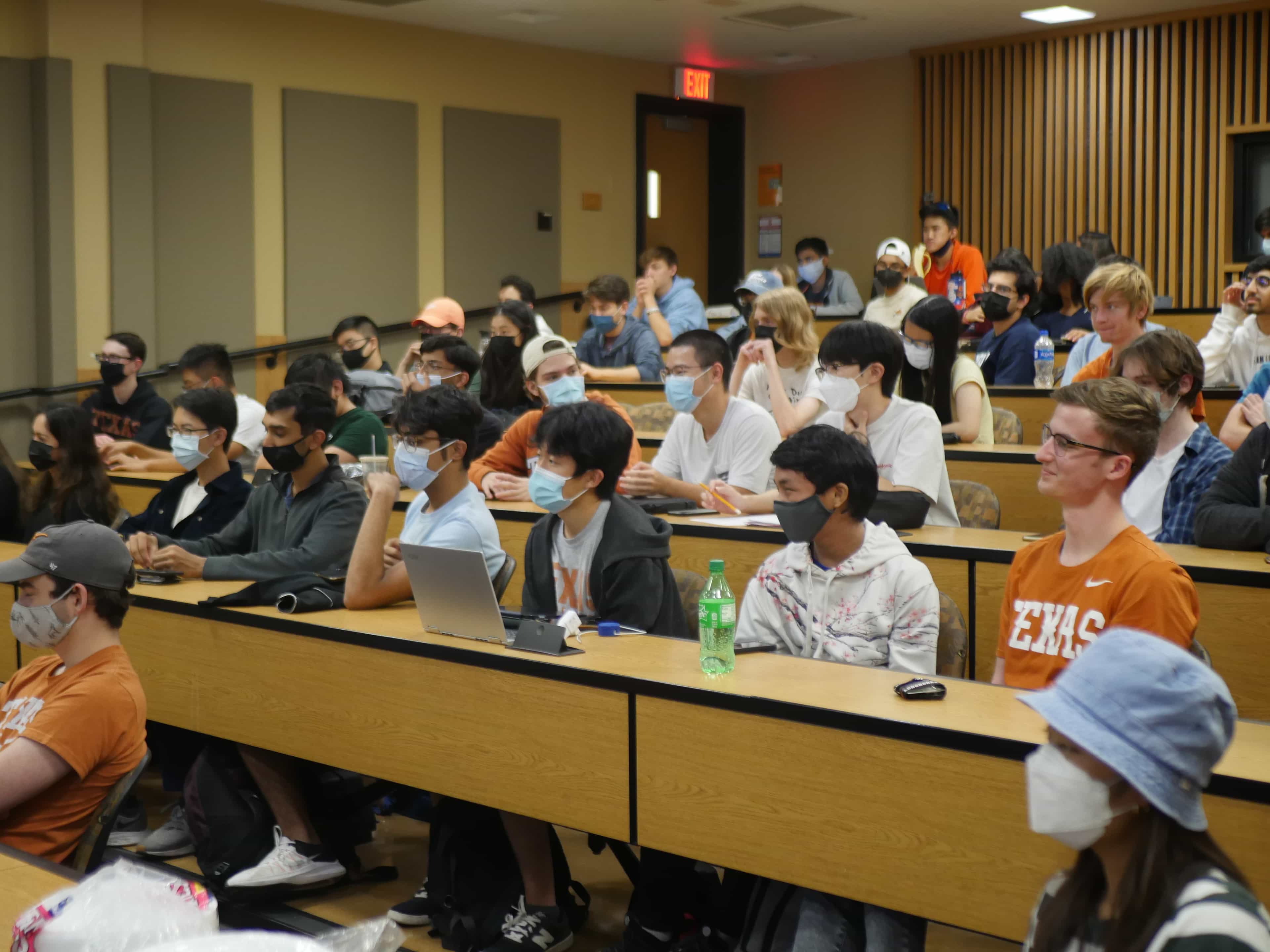 Students focusing on general meeting presenter.