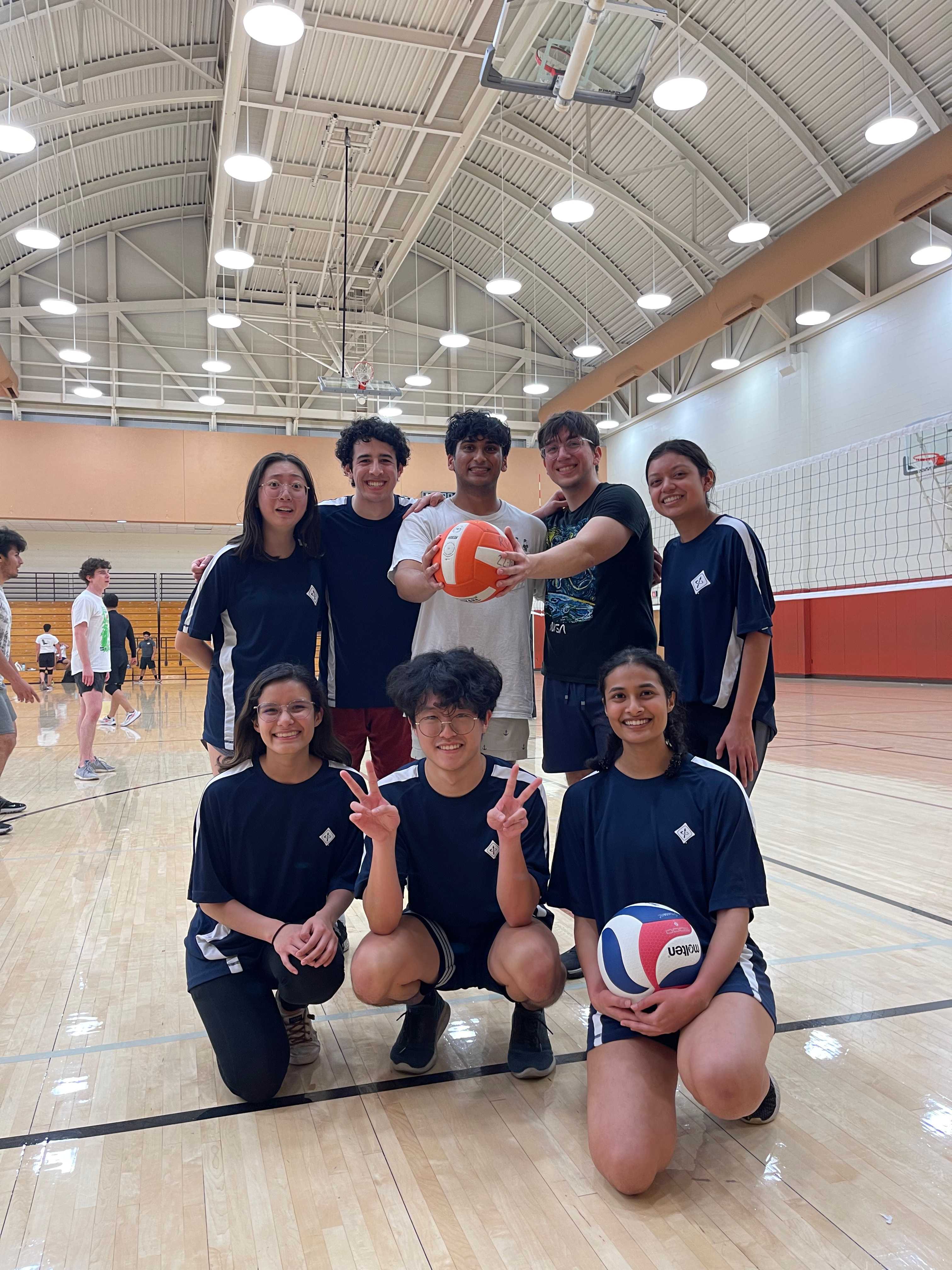 Group photo of volleyball intramural team on volleyball court