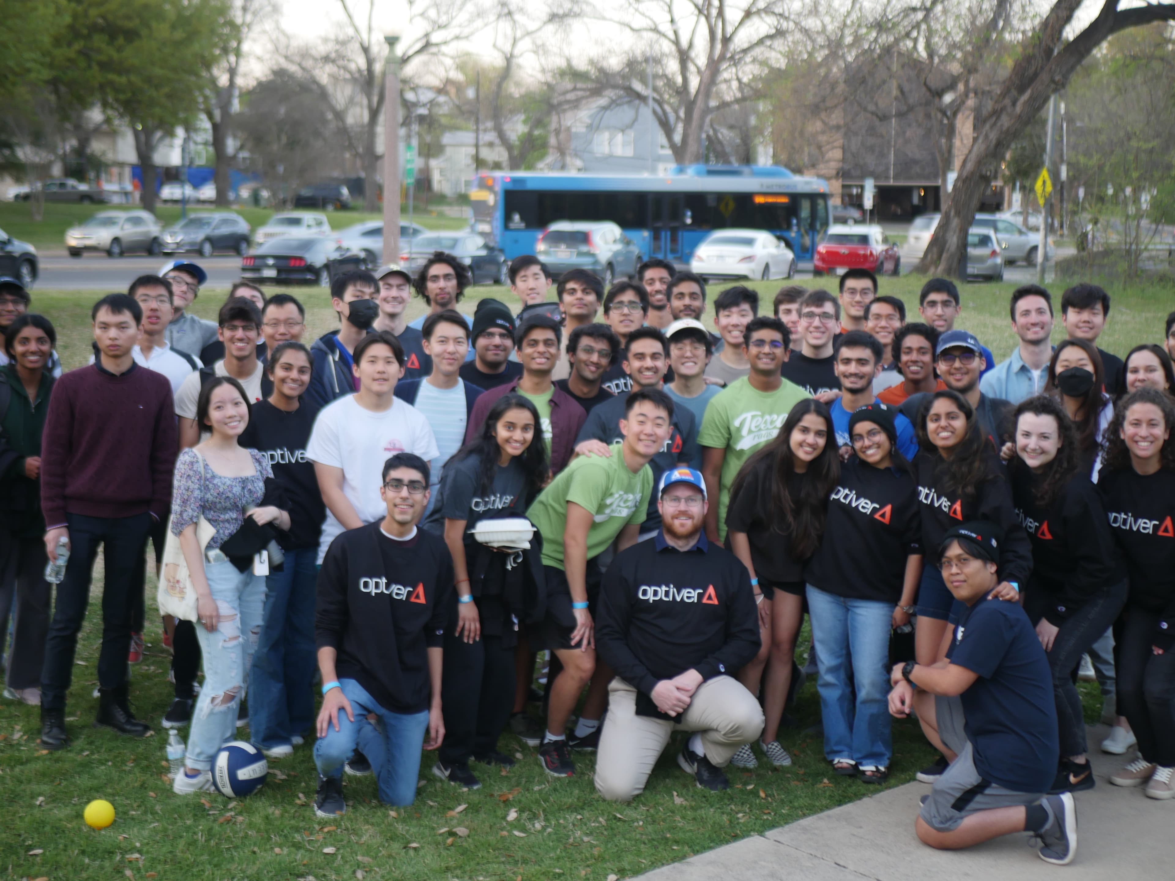 Group photo of IEEE members and Optiver representatives outside on lawn.